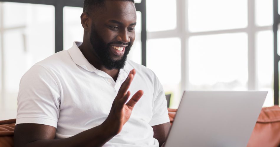 Website first impressions shown through a Nigerian business owner reviewing a modern, professional website design