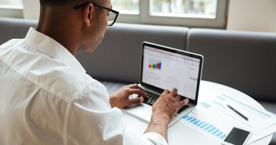 A business owner examining website performance on a laptop, with a server and speedometer graphics symbolizing how web hosting speed and reliability impact Google search rankings.